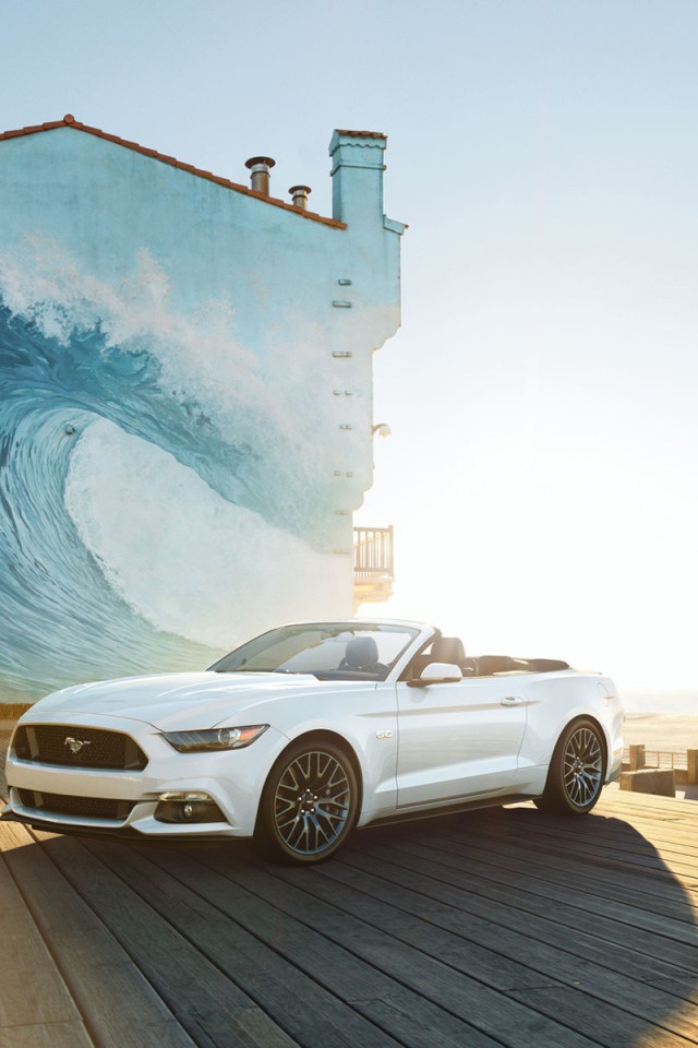 Mustang convertible on the background of the drawing on the building