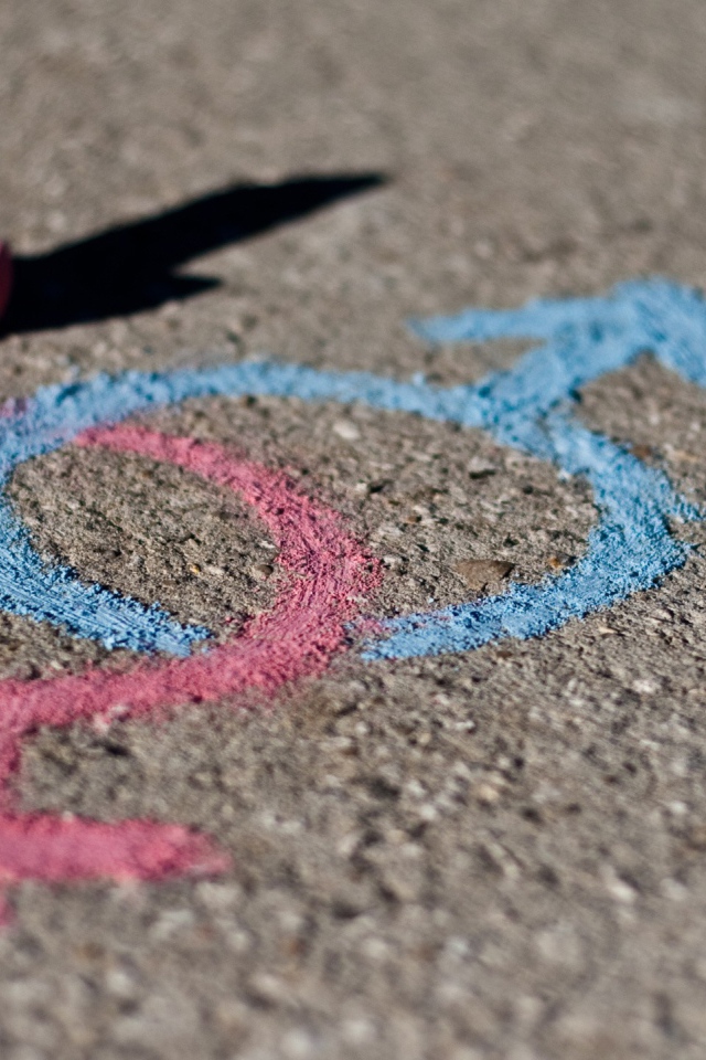 Drawing with chalk on the pavement, love
