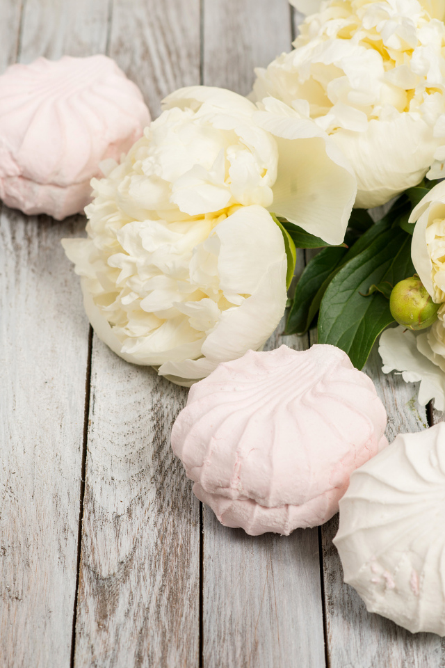 Sweet marshmallow on a table with white peonies