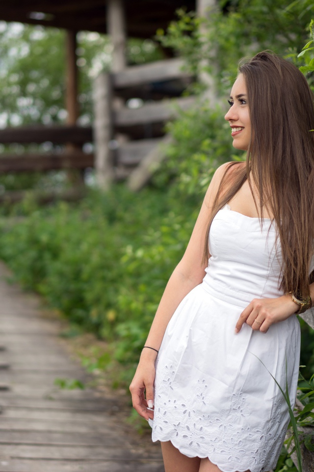 Beautiful long-haired girl model in white dress