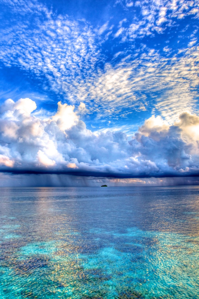 Beautiful clouds reflected in the blue water of the ocean