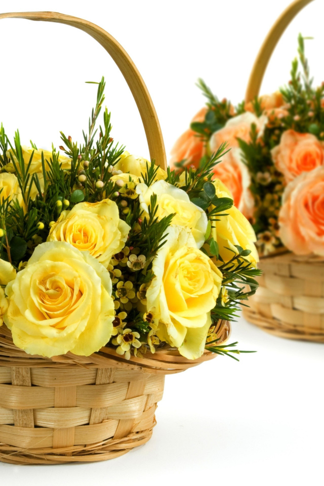 Two baskets with yellow and orange roses on a white background