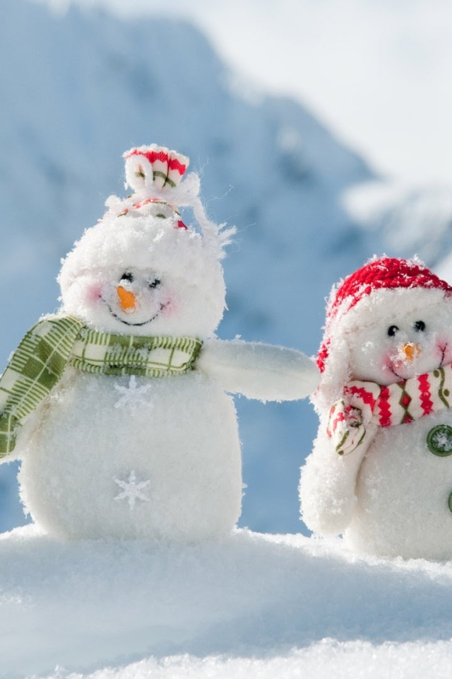 Three cheerful snowman on snow