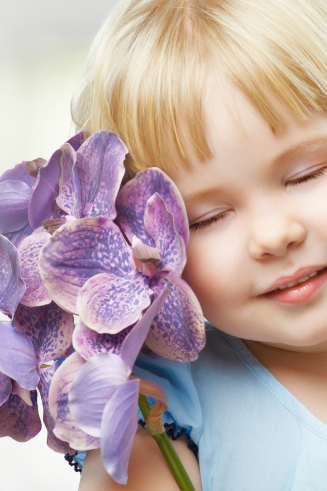 Маленькая девочка блондинка с цветами орхидеи