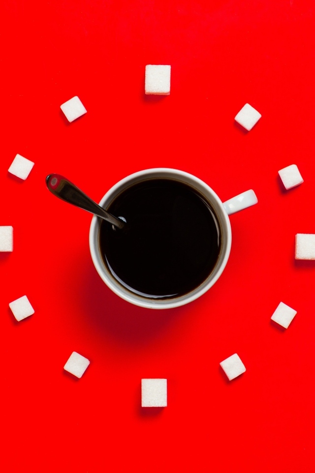 Чашка кофе с сахаром на красном фоне