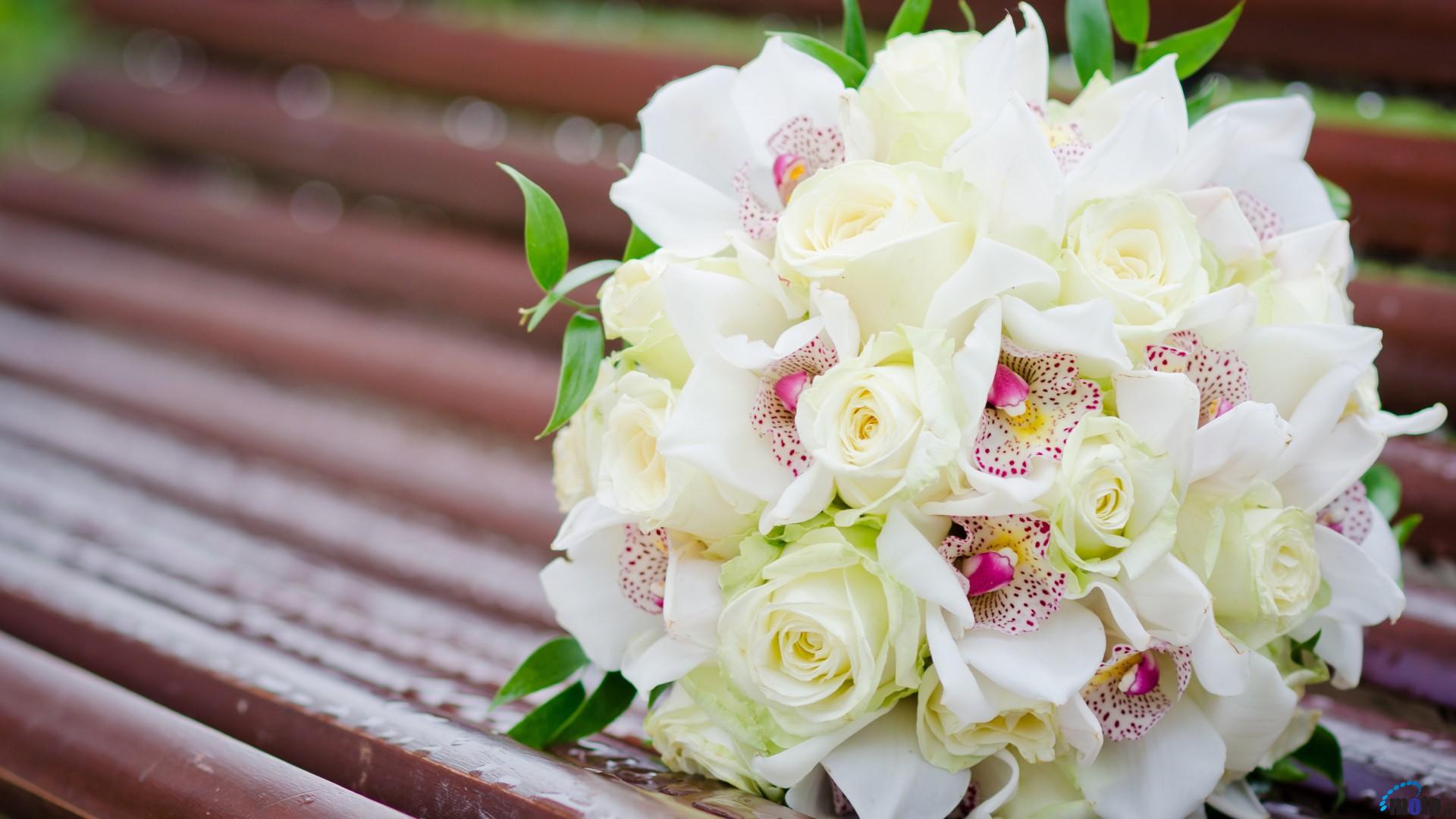 White roses and other flowers in a wedding bouquet ...