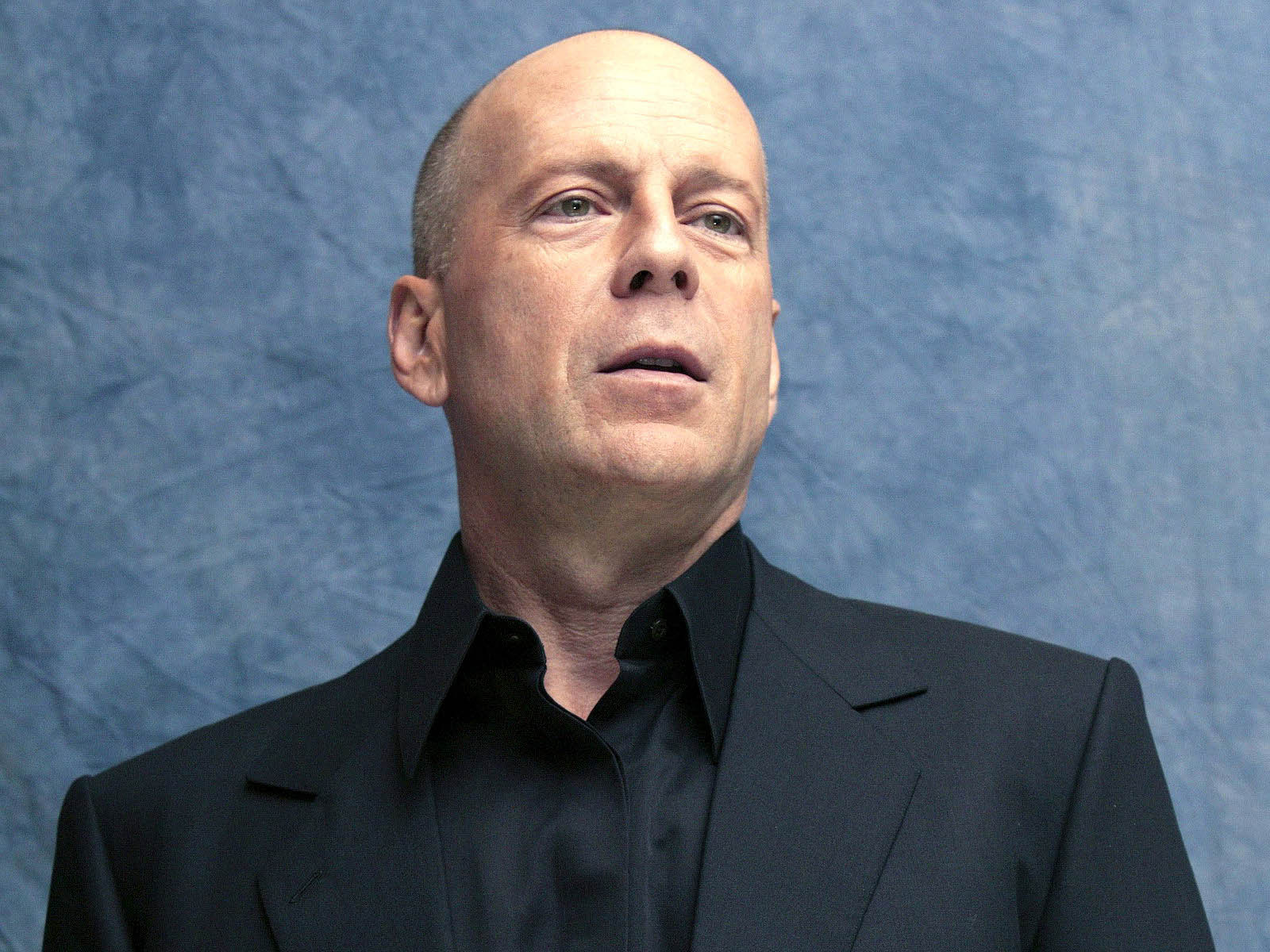 The famous actor Bruce Willis on a blue background wallpapers and