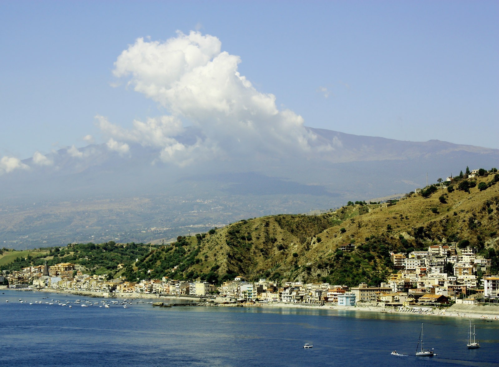 City on background volcano Etna, on the island of Sicily, Italy