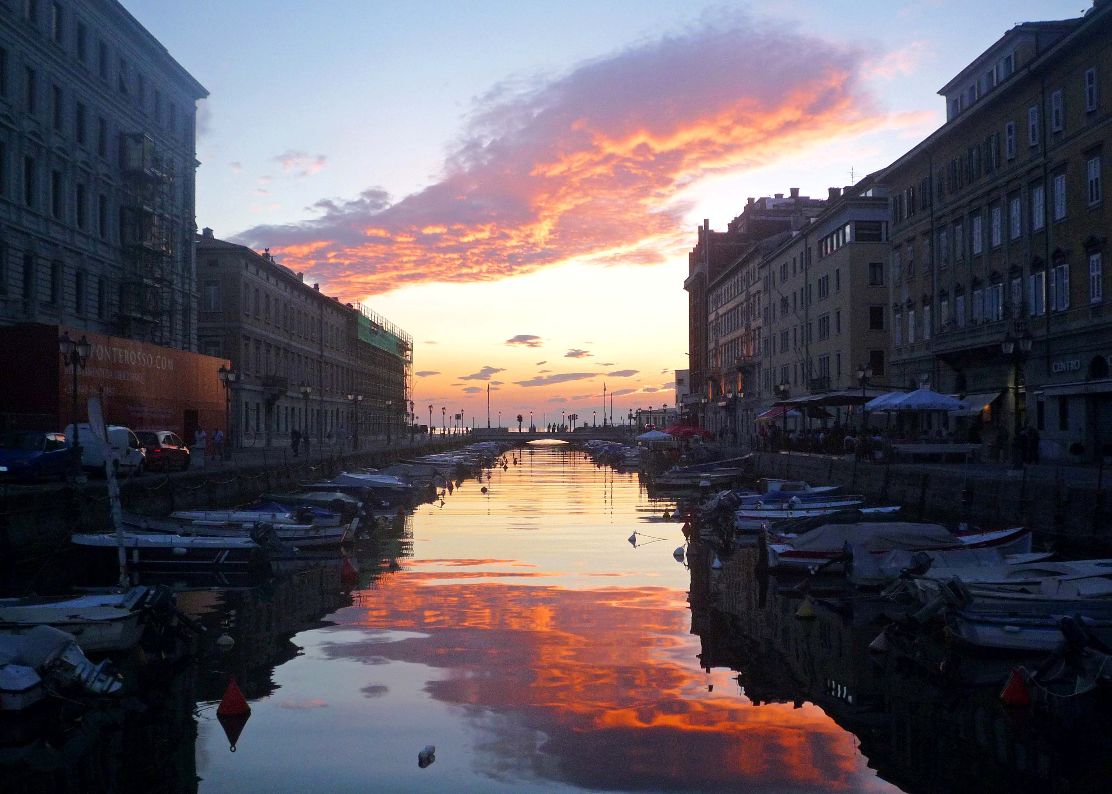 Sunset over a large channel at a resort in Trieste, Italy wallpapers