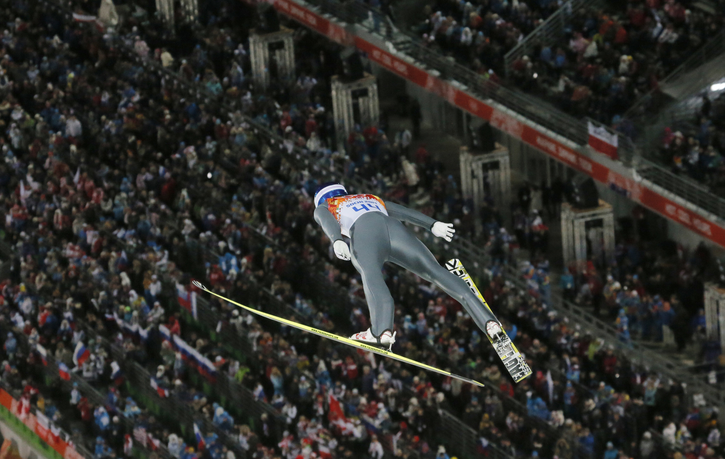 Jump jumping on the background of the stands at the Olympic Games in