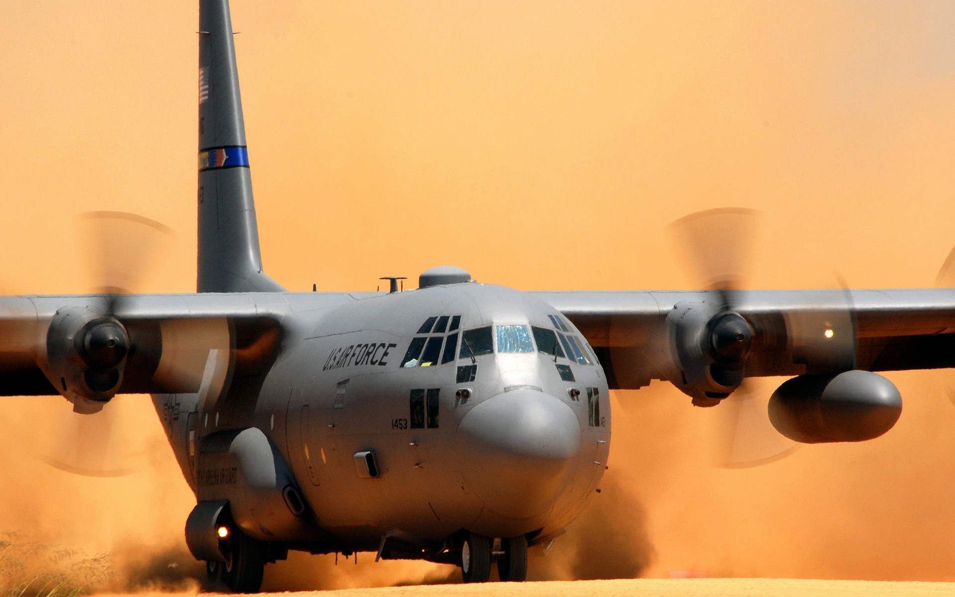 Transport aircraft AC-130 sits on the sand wallpapers and images