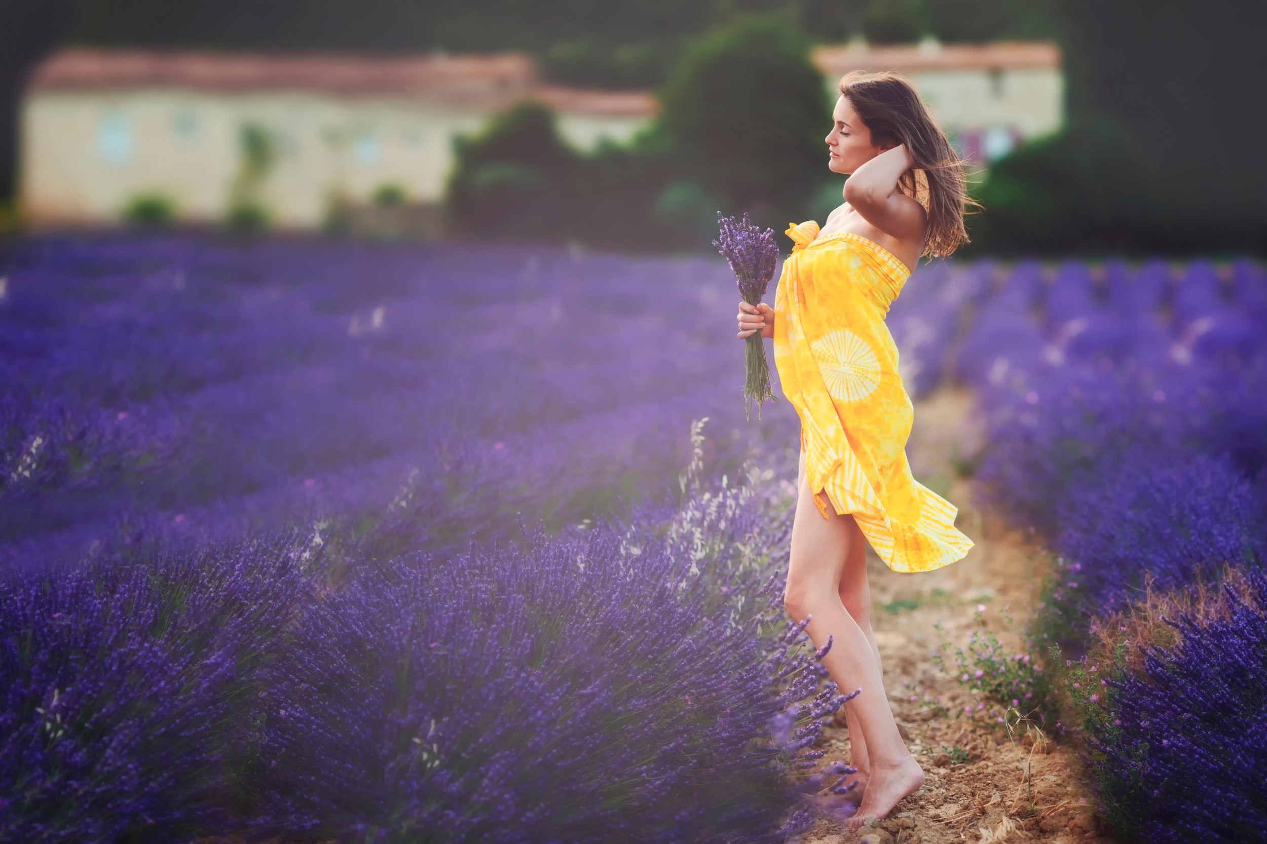 A girl in a yellow dress among the lavender fields