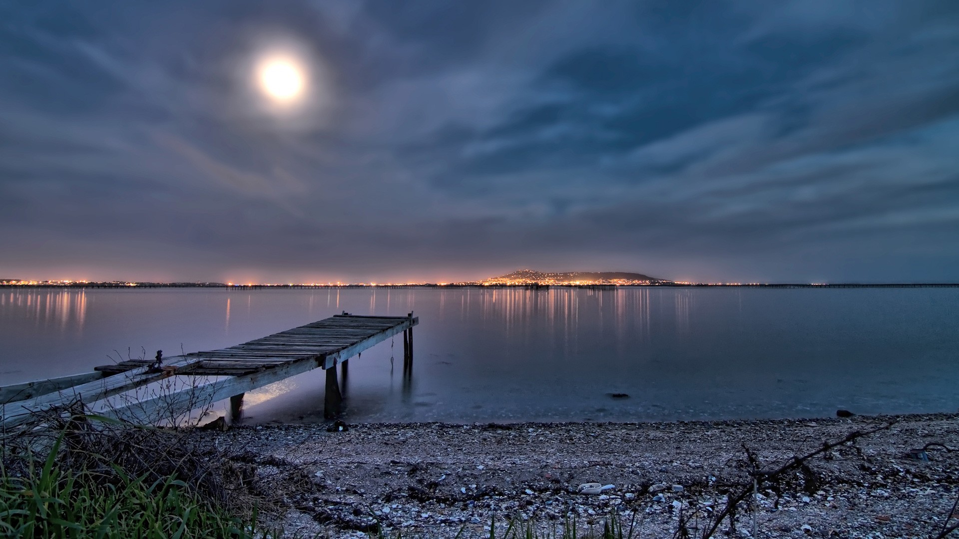 Moon over the beach at night with city views wallpapers and images