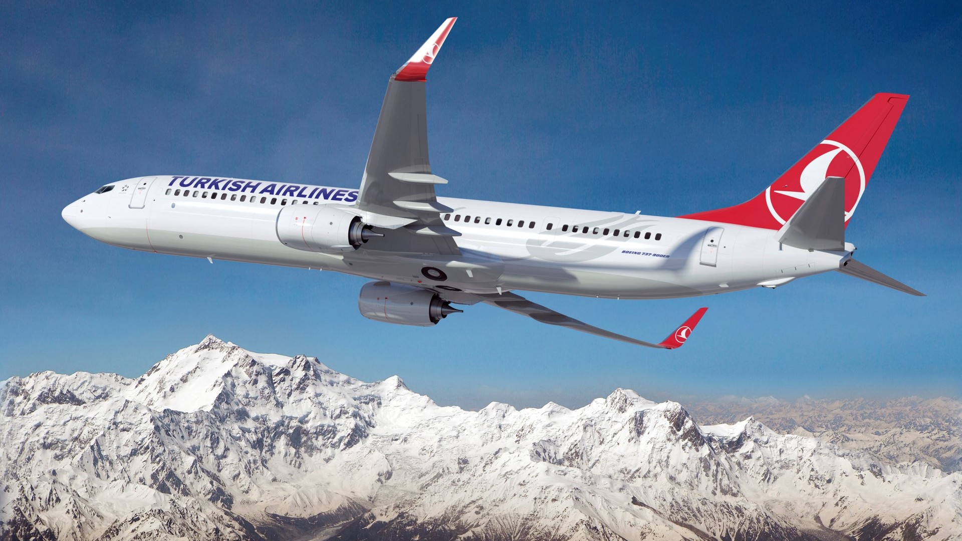 Boeing 737 900ER Turkish Airlines airline flies over the snowcapped