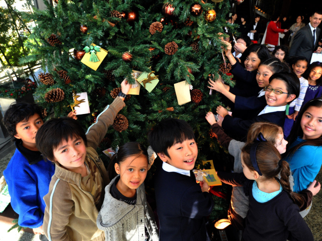 Дети рядом с новогодней елкой