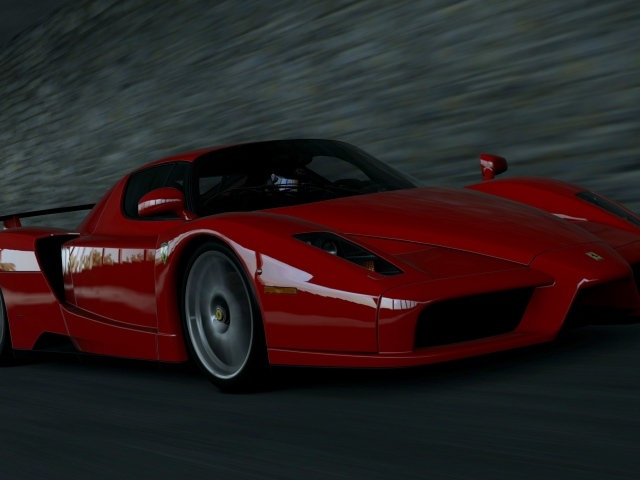 Красный Ferrari Enzo мчится на черном фоне