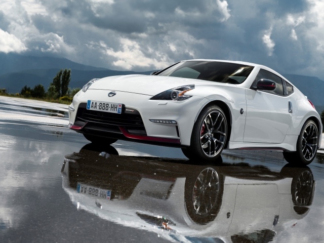 Белый спортивный автомобиль Nissan на мокром асфальте