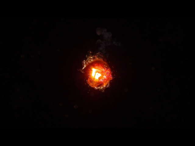 Горящий уголек, черный фон