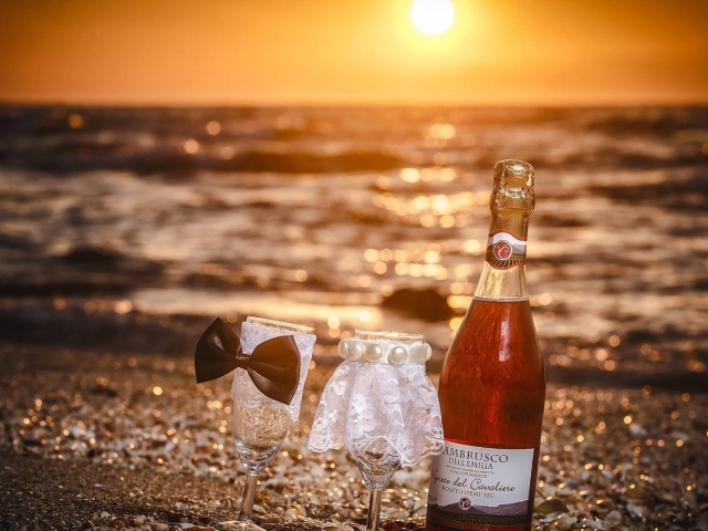 Бутылка вина и бокалы для пары на пляже