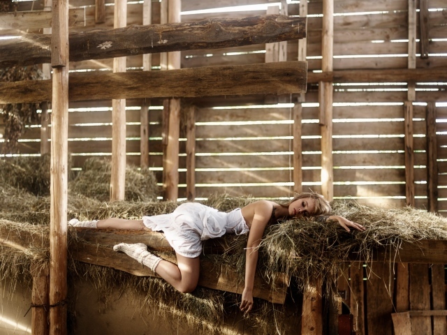 Девушка спит на сене в сарае