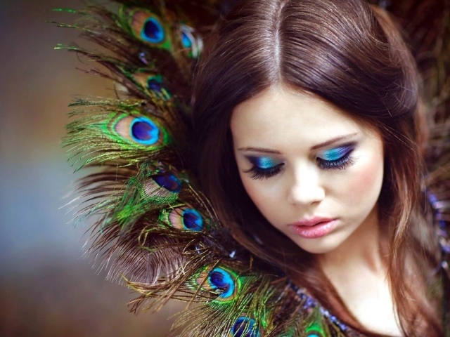 Воротник у девушки из перьев павлина
