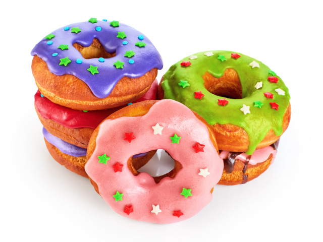 Аппетитные разноцветные пончики на белом фоне