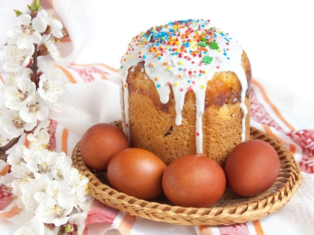 Пасхальный кулич и яйца на праздничном столе 
