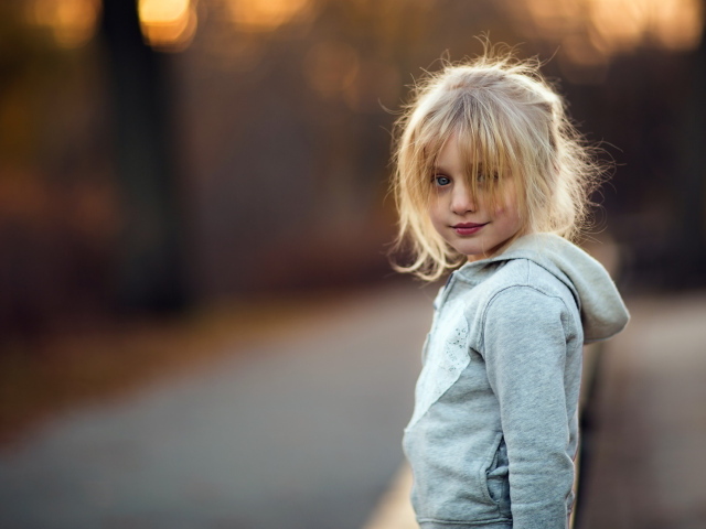Маленькая девочка блондинка в серой кофте
