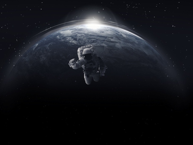 Астронавт в открытом космосе на фоне планеты земля 