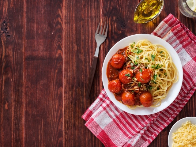Спагетти с помидорами и сыром на столе