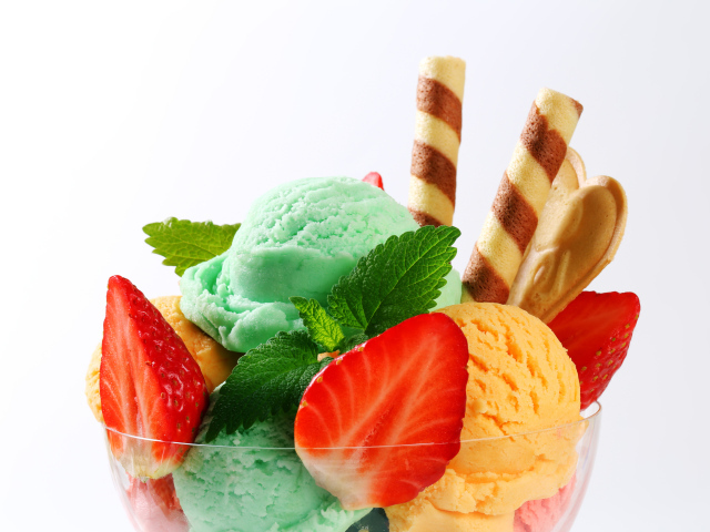 Шарики разноцветного мороженого с клубникой и трубочками