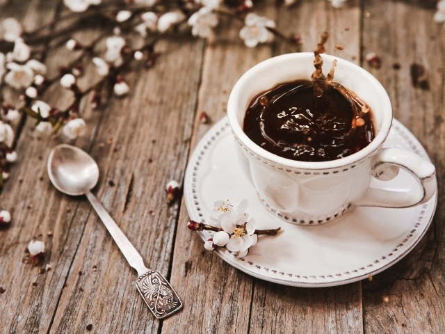 Чашка кофе на столе с цветами абрикоса