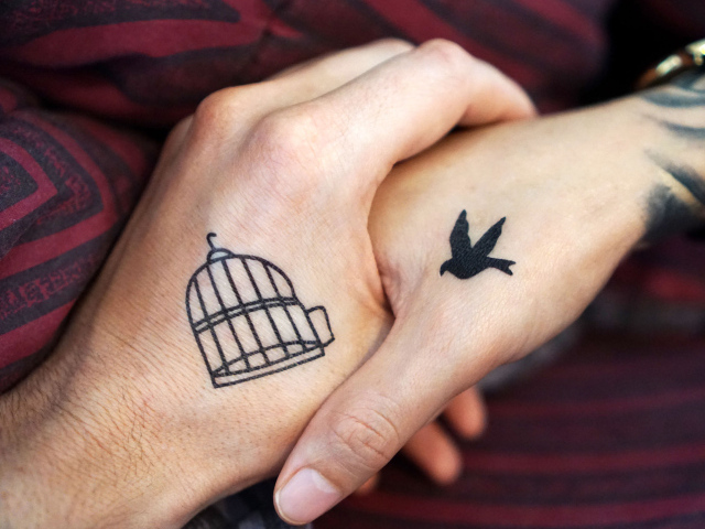 Влюбленная пара с татуировками на руках 