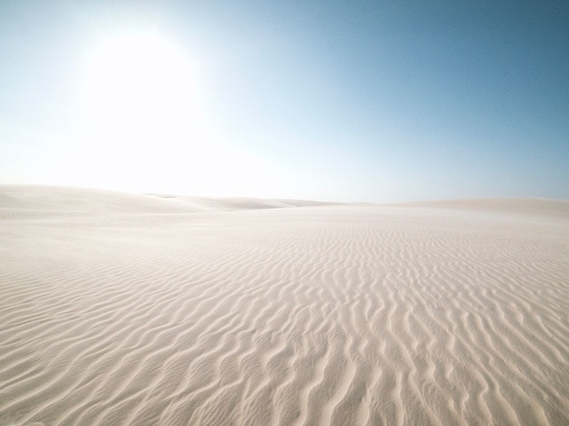 Белый песок в пустыне на фоне голубого неба