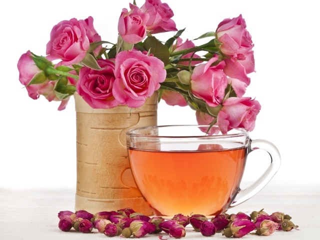 Букет розовых роз с чашкой чая на белом фоне