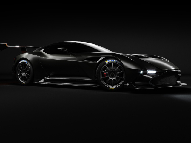 Черный спортивный автомобиль Aston Martin Vulcan на сером фоне