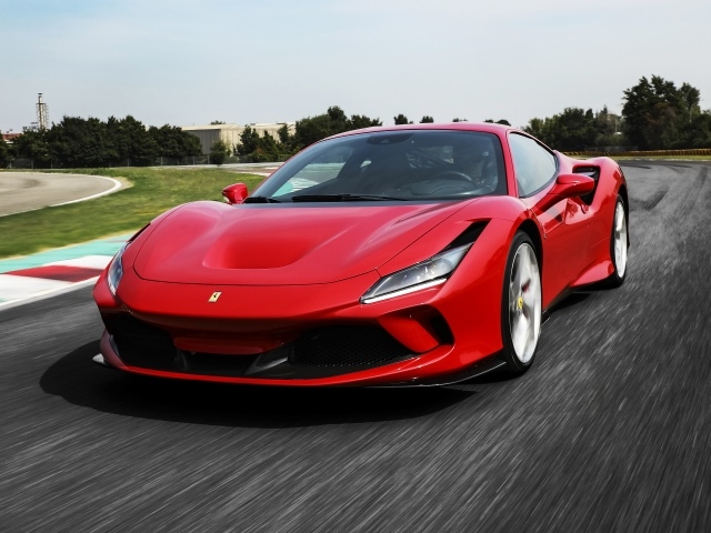 Красный быстрый автомобиль Ferrari F8 Tributo 2019 года на трассе