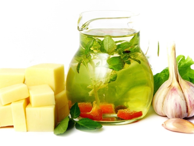 Рассол в кувшине на белом фоне с сыром и чесноком
