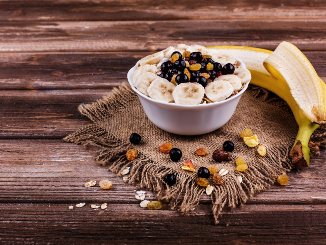 Хлопья с ягодами и бананом на столе к завтраку