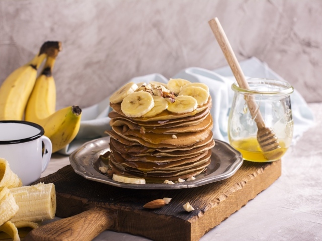 Оладьи с медом и бананами на столе