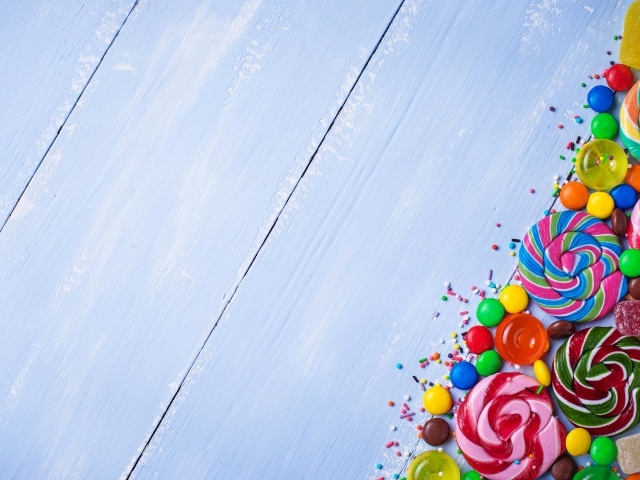 Разноцветные конфеты на голубом столе