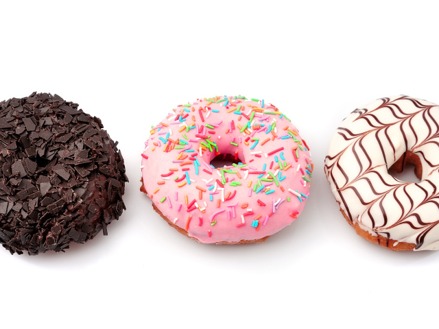 Три аппетитных сладких пончика с глазурью на белом фоне