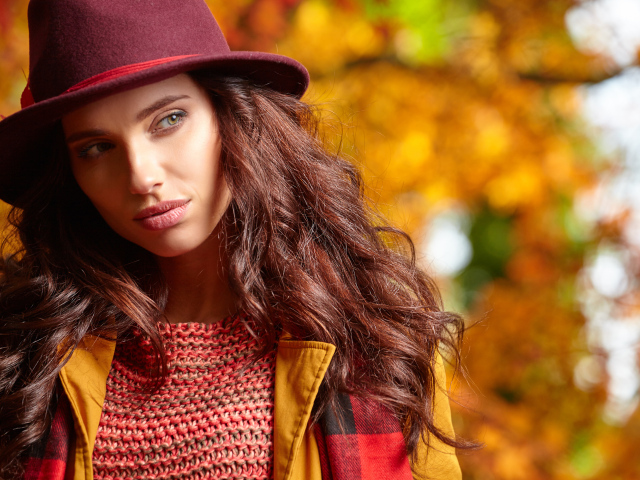 Красивая длинноволосая девушка в шляпе осенью