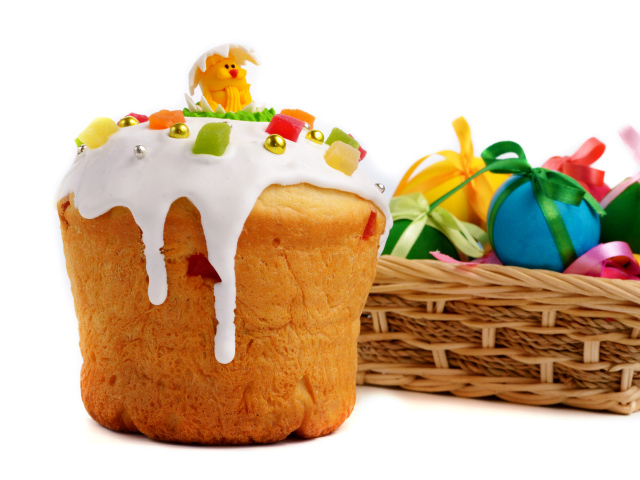 Красивый пасхальный кулич на белом фоне с корзиной крашеных яиц к празднику Пасха