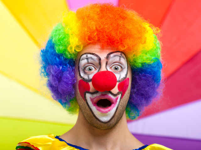 Удивленный мужчина в костюме клоуна 