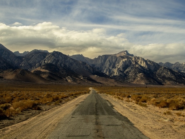 Длинная безлюдная дорога уходит в горы