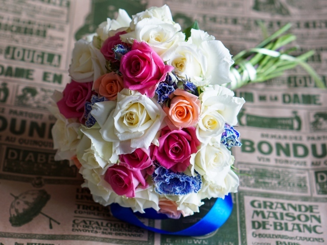 Красивый свадебный букет из роз лежит на газете