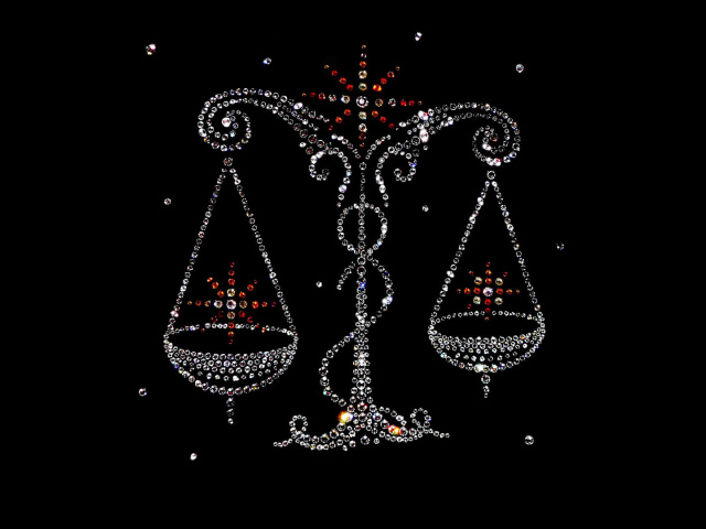 Блестящий знак зодиака весы на черном фоне