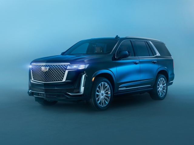 Черный Cadillac Escalade Luxury, 2021 года на сером фоне