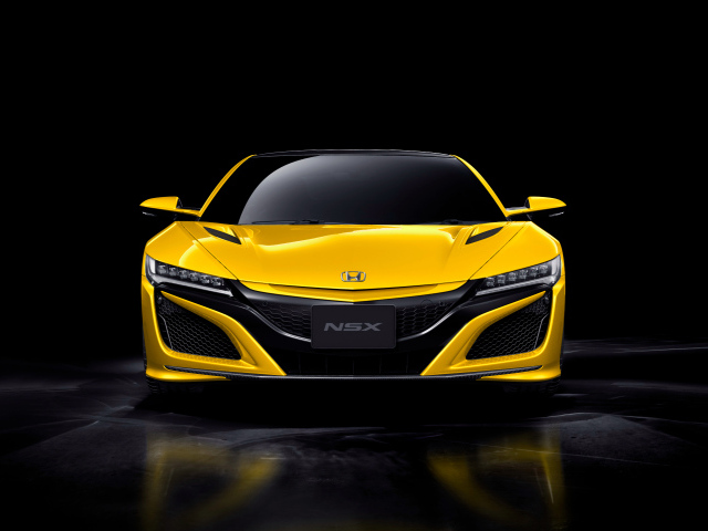 Желтый спортивный автомобиль Honda NSX на черном фоне